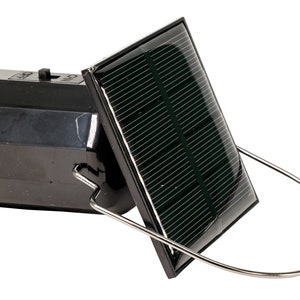 May include: A black solar powered lantern with a silver hook. The lantern has a small solar panel on the side.