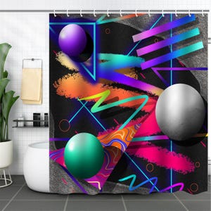 May include: A shower curtain with a geometric pattern in bright colors, including pink, blue, green, and purple. The pattern features spheres, lines, and abstract shapes.