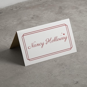 Classic folded name card, old money style, cream with deep red burgundy script writing and border.