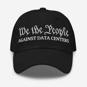 May include: A black baseball cap featuring white embroidered text on the front. The top line reads We the People in a stylized font, and the bottom line reads AGAINST DATA CENTERS in a bold, capitalized sans-serif typeface.