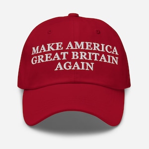 May include: A red baseball cap featuring the embroidered text "MAKE AMERICA GREAT BRITAIN AGAIN" in white. The cap has a curved peak and a rounded crown. The hat is a solid red colour.