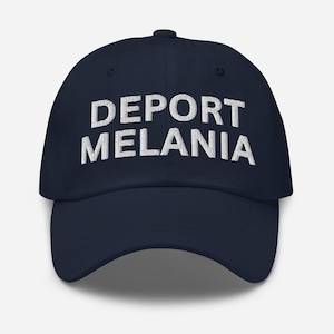 May include: Navy blue baseball cap with the white embroidered text "DEPORT MELANIA" across the front. The cap has a curved brim and a button on top.