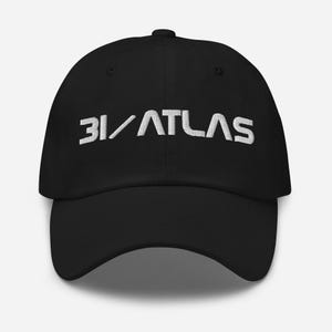May include: Black baseball cap with the white embroidered text "31/ATLAS" across the front. The cap has a curved brim and a fabric strap closure on the back.