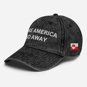 May include: Black vintage style baseball cap with the text "Make America Go Away" in white embroidery and a small red and white flag of Greenland on the side.