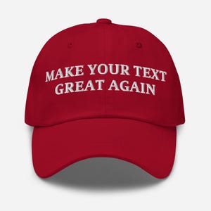 May include: Red baseball cap with white embroidered text that reads "Make Your Text Great Again".