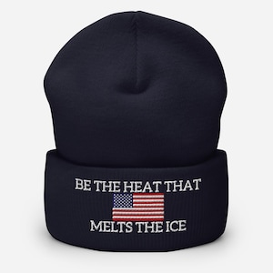 May include: Navy blue beanie with the embroidered text "BE THE HEAT THAT MELTS THE ICE" and a small American flag. The hat is a classic winter accessory, perfect for cold weather.