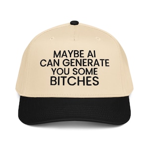 May include: A baseball cap with a beige crown and a black peak. The cap features the text "MAYBE AI CAN GENERATE YOU SOME BITCHES" in bold, black letters. The cap has a black button on top.