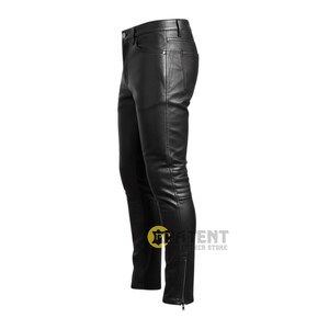May include: Black leather trousers with a classic five-pocket design and a zip closure at the ankle. The trousers are made of a smooth, shiny leather material. The trousers are shown from a side view.