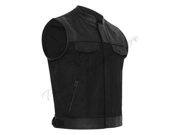 May include: A black leather vest with a stand-up collar, two chest pockets, and a zippered pocket. The vest has a suede-like texture on the front and a leather trim at the bottom. A classic biker-style vest.