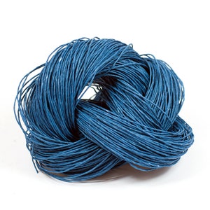May include: A close-up of a blue paper cord, twisted into a knot. The cord is made of thin, woven strands of paper.