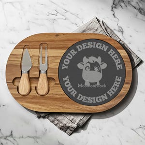 May include: Wooden cheese board with a dark gray slate insert. Includes a cheese knife and fork with wooden handles. The slate insert has a cow graphic and the text "YOUR DESIGN HERE" around the edge.