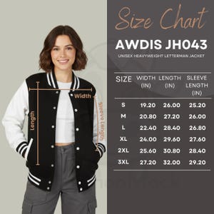 May include: A black and white unisex heavyweight letterman jacket with a size chart. The jacket has white sleeves and a black body with white stripes on the cuffs and hem. The size chart shows measurements in inches.