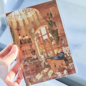 Carte postale « Cosy Cat Cafe » – Illustration chaleureuse et accueillante du « Cat Cafe », parfaite pour les amoureux des chats