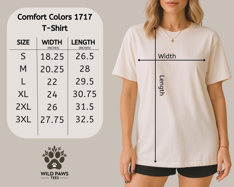 Op de afbeelding: Cr&egrave;mekleurig Comfort Colors 1717 T-shirt met maattabel. De tabel toont breedte- en lengtematen in inches voor de maten S tot en met 3XL. Het Wild Paws Tees-logo staat onderaan.