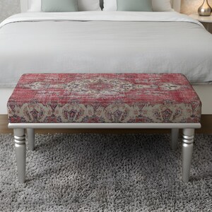 May include: A rectangular bench with a red and cream patterned top and silver legs. The bench is placed in front of a bed with a white duvet and pillows. The bench is approximately 122 cm long.