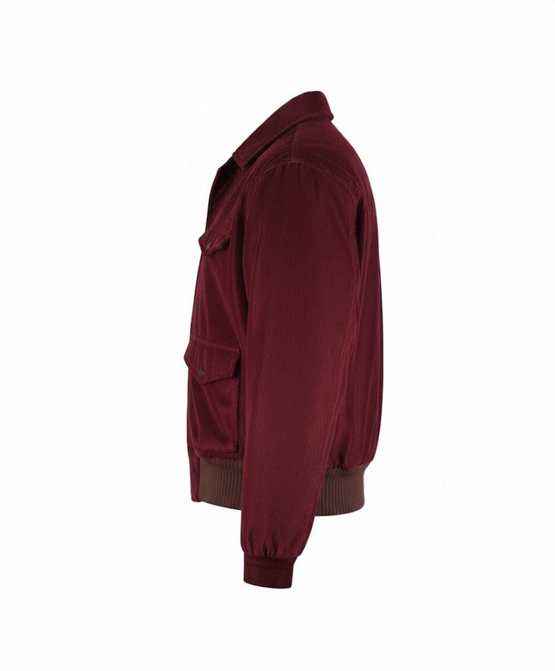 May include: A burgundy corduroy jacket with a classic collar and two front pockets. The jacket features a brown ribbed hem and cuffs. This casual jacket is a stylish outerwear option.