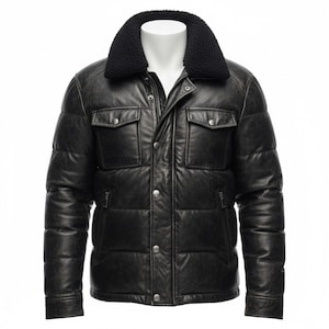 May include: Black leather puffer jacket with a black faux fur collar. The jacket has two chest pockets, two side pockets, and a zipper closure. The jacket is displayed on a white mannequin.