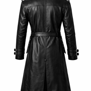 May include: A black leather trench coat with a belted waist and double-breasted design. The coat features a notched collar, epaulettes, and buttoned cuffs. The coat's length extends to the mid-calf.