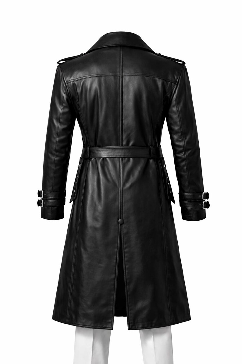 May include: A black leather trench coat with a belted waist and double-breasted design. The coat features a notched collar, epaulettes, and buttoned cuffs. The coat's length extends to the mid-calf.
