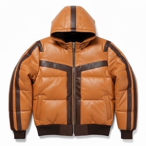 May include: A tan leather puffer jacket with a hood and dark brown accents. The jacket features a zip-up front, two front pockets, and dark brown stripes on the sleeves and hood. The jacket has a ribbed hem and cuffs.