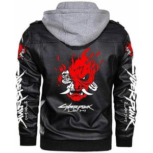 May include: Black faux leather jacket with a grey hooded insert. The back features a red and white graphic of a demon face with flames. White text is on the sleeves and below the graphic. A stylish jacket for fans of the Cyberpunk genre.