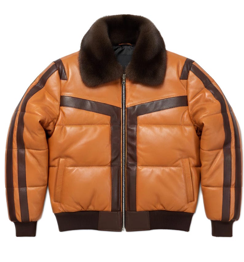 May include: A brown and tan leather puffer jacket with a fur collar. The jacket features dark brown stripes on the sleeves and across the chest. It has a zipper closure and a ribbed hem and cuffs. A stylish outerwear piece.