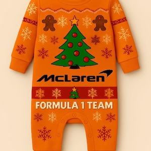 May include: Orange baby one-piece with a Christmas tree and gingerbread men design. Features the McLaren Formula 1 Team logo. Includes snowflake and star patterns. Made for infants.