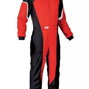 May include: A red and black racing suit with white accents and the "OMP" logo. The suit has a full-length zipper, black cuffs, and a black collar. This racing suit is designed for motorsports.