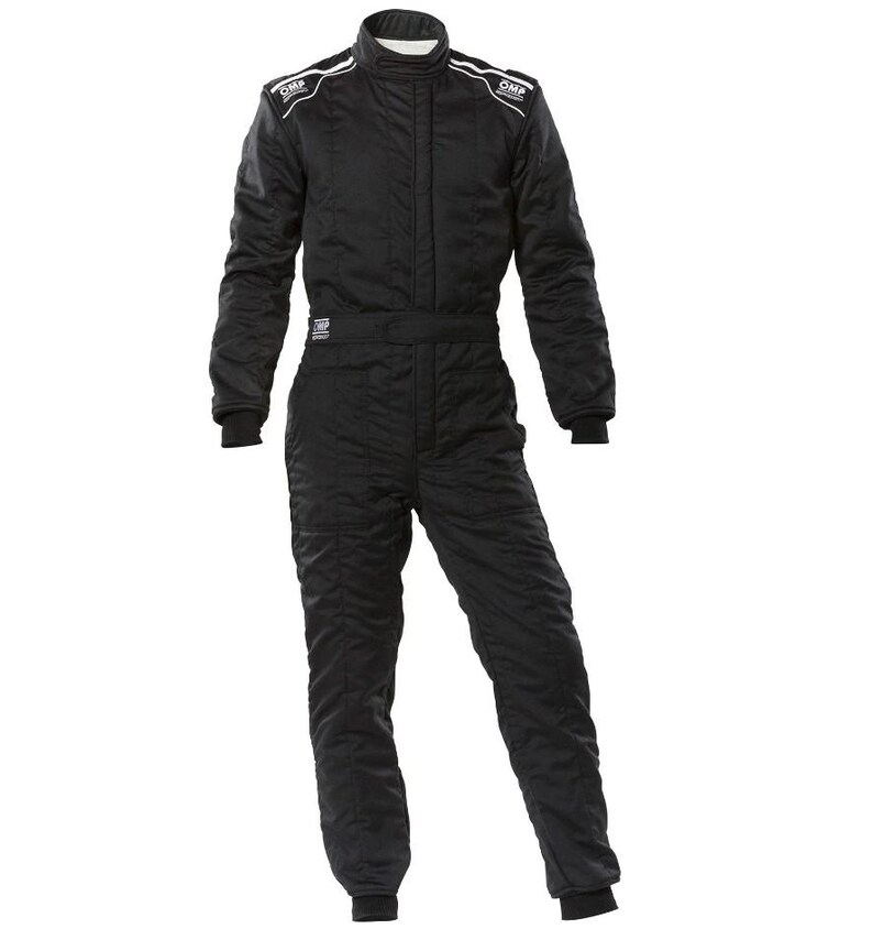 May include: Black racing suit with white accents and the OMP logo on the shoulders. The suit has a high collar, long sleeves, and a zippered front. The suit is designed for motorsports and features a fitted silhouette.