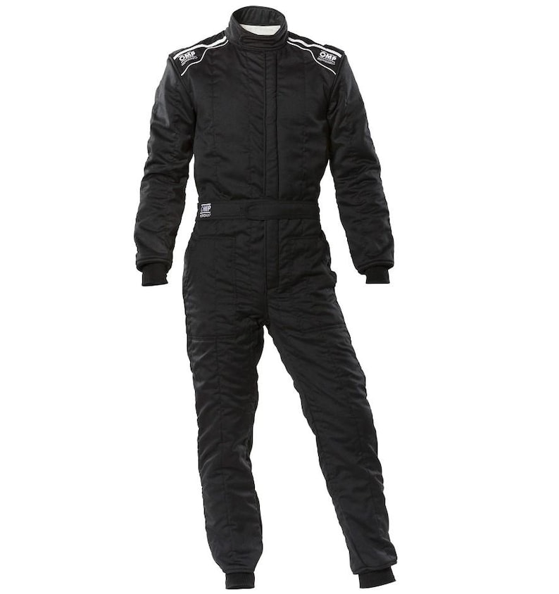 May include: Black racing suit with white accents and the OMP logo on the shoulders. The suit has a high collar, long sleeves, and a zippered front. The suit is designed for motorsports and features a quilted pattern.