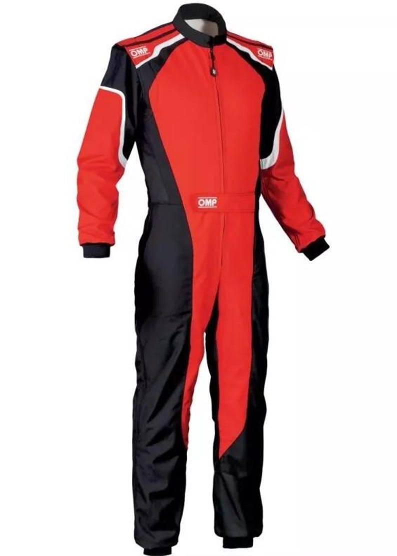 May include: A red and black racing suit with white accents and the "OMP" logo. The suit has a full-length zipper, black cuffs, and a black collar. This racing suit is designed for motorsports.