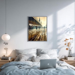 May include: A framed watercolor painting depicts a rainy day scene with figures walking along a covered walkway. The artwork features a muted color palette of browns, yellows, and grays, with reflections on the wet ground. The painting is displayed above a bed.