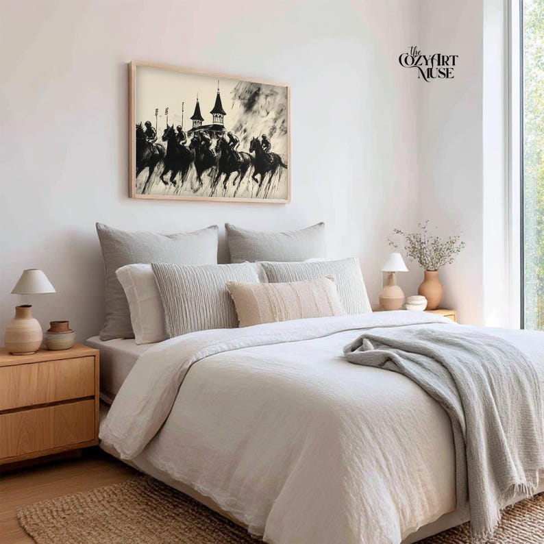 May include: A framed black and white print of horses racing towards a building with spires hangs above a bed with neutral-toned bedding. The Cozy Art Muse text is visible in the upper right corner. The room is decorated in a minimalist style.