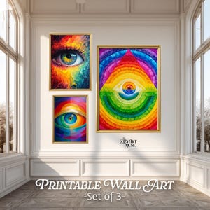 May include: A set of three framed art prints with eye-themed designs. The prints, in gold frames, depict a detailed eye, a rainbow eye, and a pyramid eye. The text "Printable Wall Art - Set of 3-" is displayed at the bottom of the image.