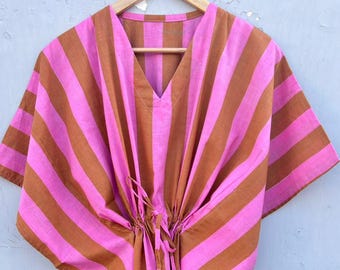 May include: A pink and brown striped kaftan with a V-neck and a drawstring waist.