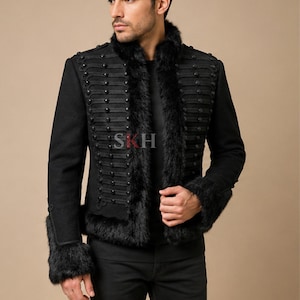 May include: Black military-style jacket with faux fur trim on the collar and cuffs. The jacket features rows of decorative buttons and a high collar. The letters "SKH" are visible on the jacket.