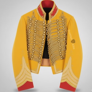 May include: A yellow military-style jacket with gold-colored embellishments and red accents. The jacket features rows of gold-colored rope and buttons, with decorative embroidery on the sleeves. The text "Scottish Kilts" is printed on the sleeve.