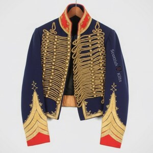 May include: A navy blue military jacket with gold-colored rope detailing and gold buttons. The jacket has a red collar and red cuffs. The text "Scottish Kilts" is printed on the sleeve.