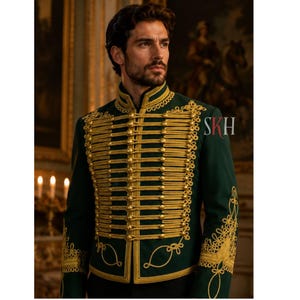 May include: A dark green military-style jacket with gold-colored trim and decorative embroidery. The jacket features multiple rows of gold braid and ornate detailing around the collar, cuffs, and front. The letters "SKH" are visible on the right sleeve.