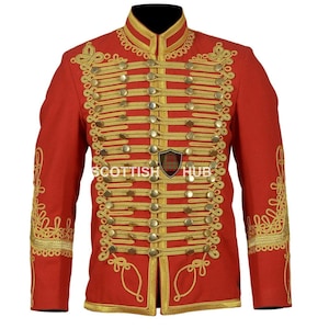 May include: A red military-style jacket with gold detailing, including buttons, trim, and embroidery. The jacket has a high collar and the text "SCOTTISH HUB".