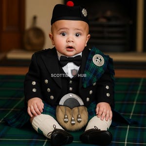 May include: A baby in a traditional Scottish outfit, featuring a black jacket, bow tie, kilt, sporran, and hat with a red pompom. The kilt is green and blue plaid. The baby is seated on a green and blue plaid surface.