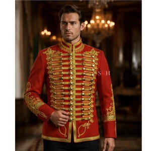 May include: A vibrant red military-style jacket featuring intricate gold embroidery and multiple horizontal gold braided cords across the chest. The garment has a high mandarin collar, long sleeves with gold cuffs, and metallic buttons.