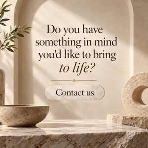 May include: A marble vase with green foliage, a marble bowl, and a circular stone sculpture on a marble surface. The text reads: Do you have something in mind you'd like to bring to life? Contact us. The background features a beige arched wall.