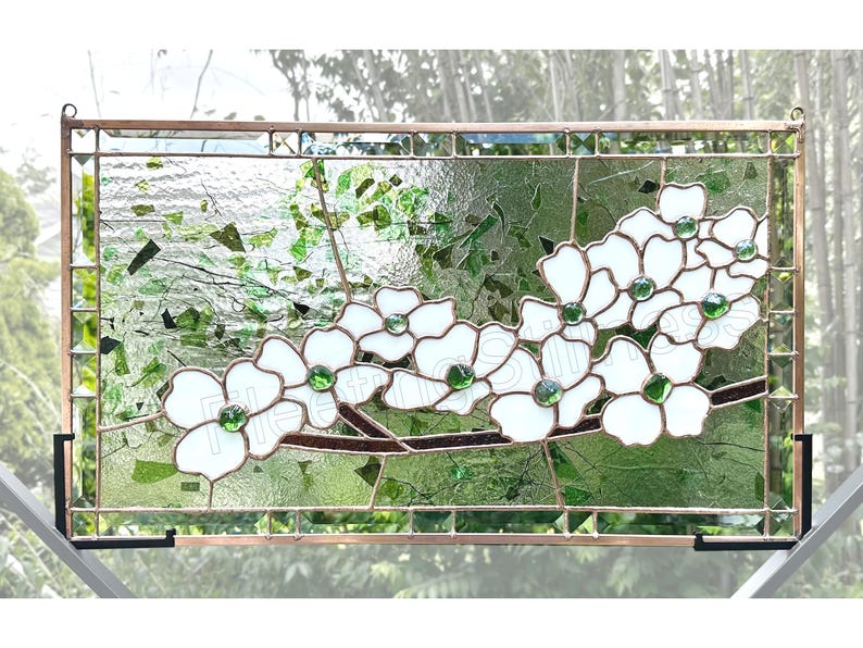 May include: A rectangular stained glass panel featuring white dogwood flowers with green glass centers on a brown branch. The background consists of textured clear and green glass pieces framed in copper metal with a grid border design.