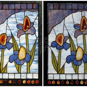 May include: Two stained glass panels featuring a design of three blue irises with agate centers. The background is a light blue with a white, cloudy pattern. The panels are framed in black.