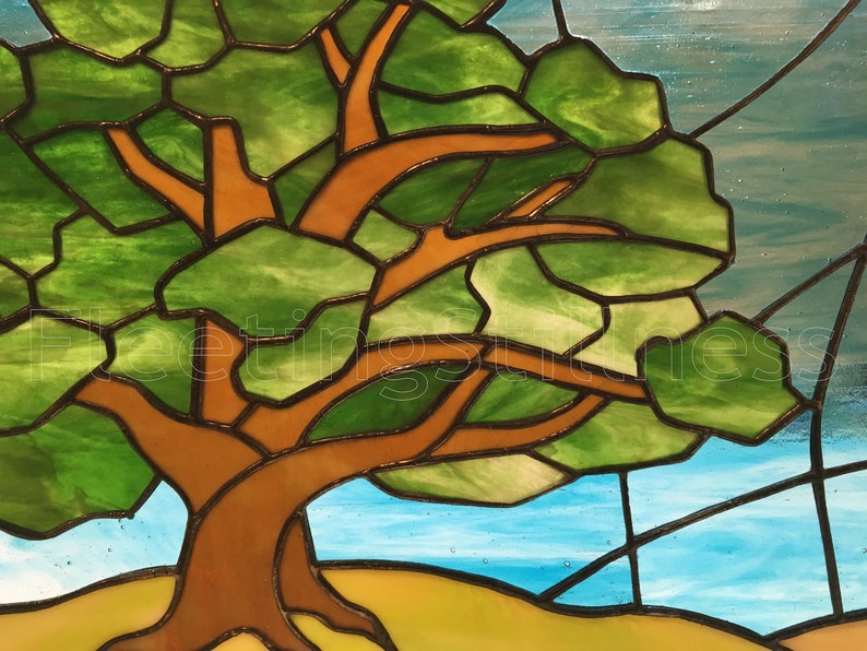 May include: A stained glass window depicting a tree with brown branches and green leaves against a blue sky background.