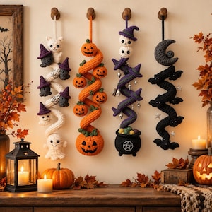 May include: Four vertical crochet wall hangings featuring Halloween themes. The first is white with ghosts and purple-hatted figures. The second is orange with jack-o'-lanterns. The third is purple with skulls and a cauldron. The fourth is black with bats and a moon.