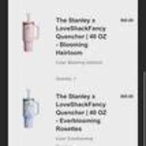 May include: Two Stanley x LoveShackFancy Quencher tumblers, 40 oz each, in Blooming Heirloom and Everblooming Rosettes colors. Each tumbler has a handle and a straw. The text "The Stanley x LoveShackFancy Quencher | 40 OZ" is visible.
