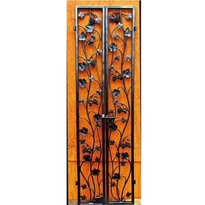 May include: A pair of black metal double doors with a decorative grapevine design. The doors are closed and have a lock in the center.