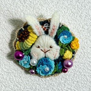 Handmade Embroidered Bunny Brooch – Whimsical Floral Pin with 3D Yarn Bunny and Crochet Flowers